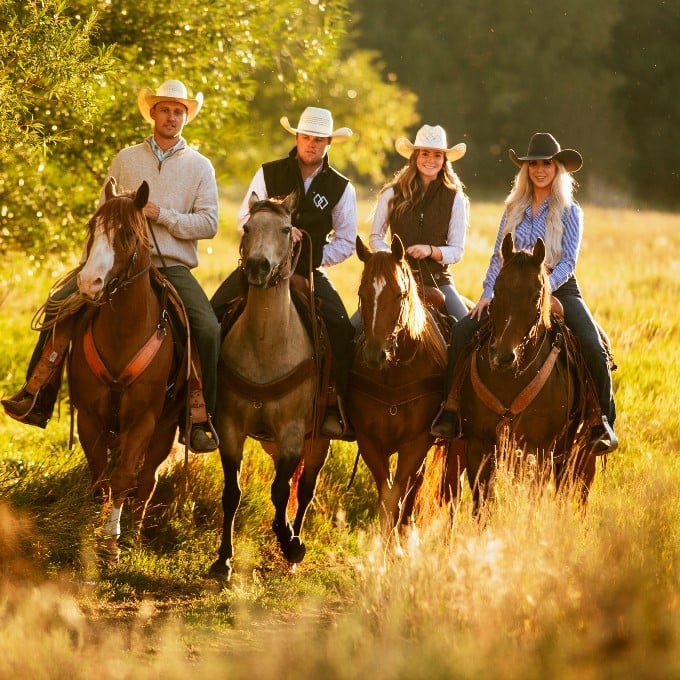 Group of 4 riding on horses