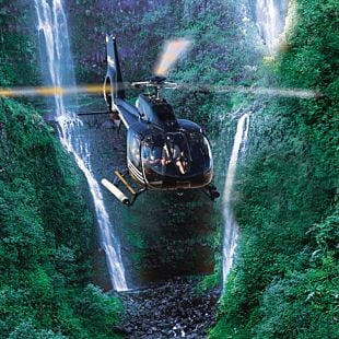 Helicopter flying over waterfalls