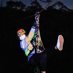 Girl on zipline at night