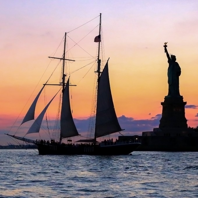 Ship at sunset with Statue of Liberty