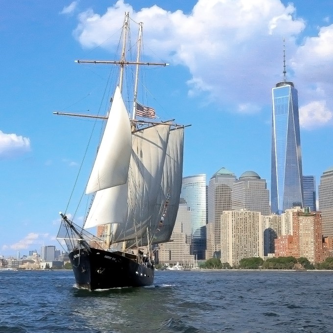 Ship sailing by city
