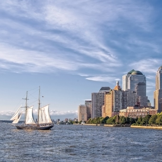 Boat sailing near city