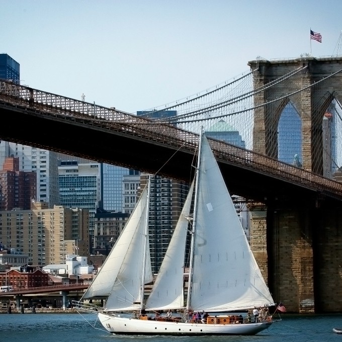 Boat sailing near bridge