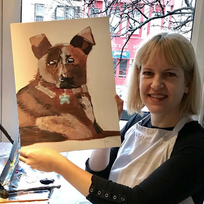 Woman Holding up Completed Dog Painting