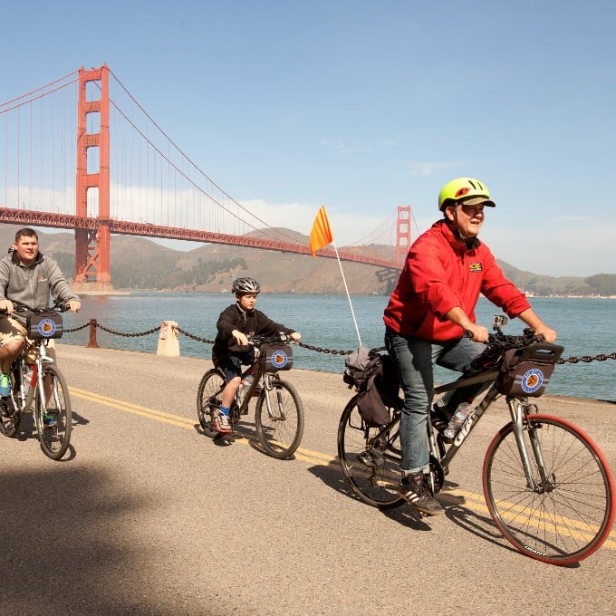 Group riding bike by Golden Gate Bridge