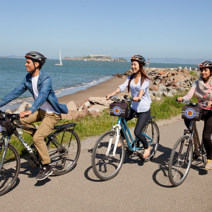 Group riding along coastline