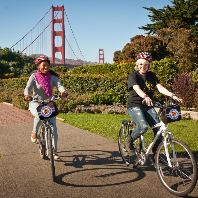 Two people riding through park