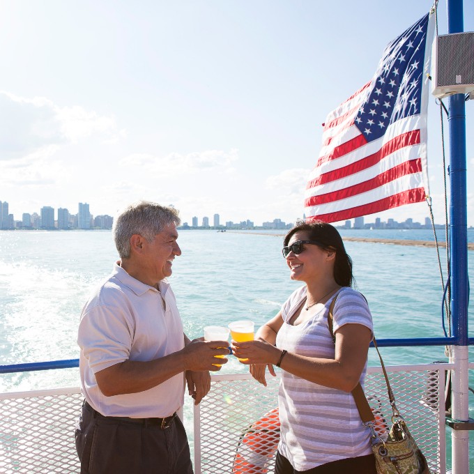 Two people enjoying drinks on lake