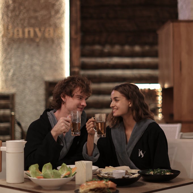Couple enjoying food and drinks in lounge
