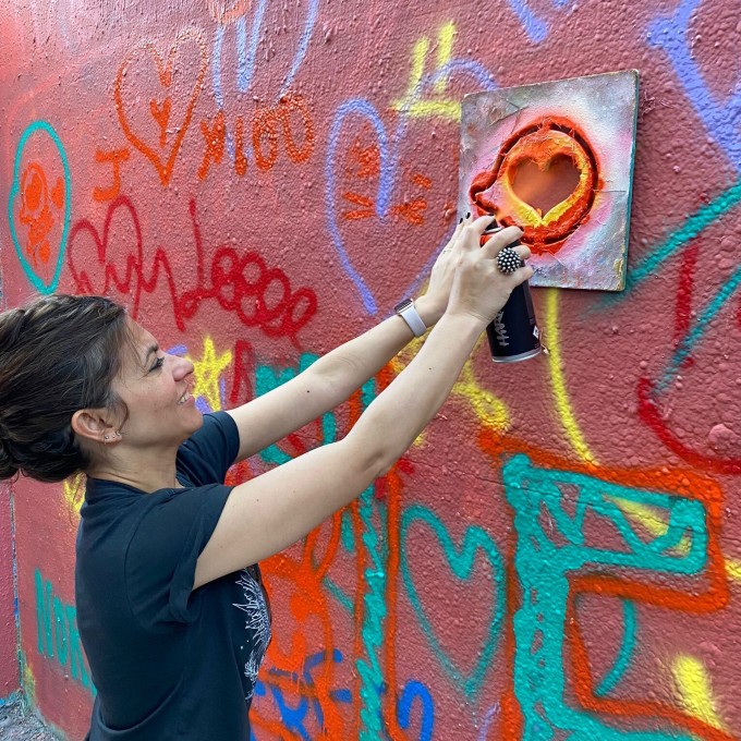 Woman spray painting a heart